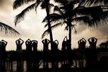 Group-doing-energization-exercises-on-beach,-India-pilgrimage-04