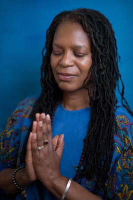 Woman absorbed in prayer, tuning into superconscious awarenes