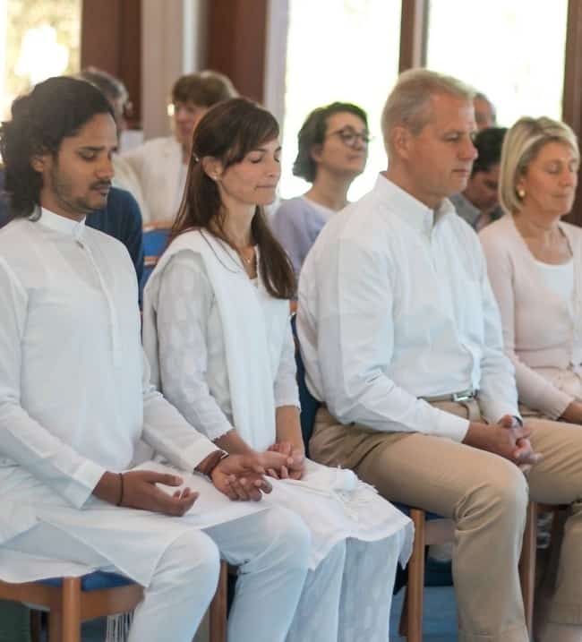 Group of people meditating in the Temple of Light, Ananda Assisi