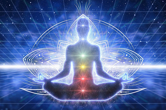Visual of meditating yogi with chakras