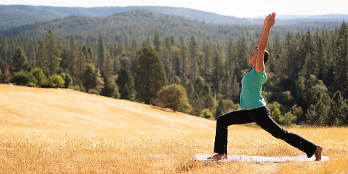 Yoga teacher Melody practicing yoga outside on Ananda Village land